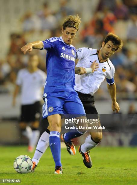 Fernando Torres of Chelsea holds off the challenge by David Albelda of Valencia during the UEFA Champions League Group E match between Valencia CF...