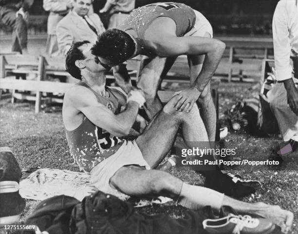 Georgian-born Soviet high jumper Robert Shavlakadze is kissed by his Soviet teammate, and runner-up, Valeriy Brumel after winning the men's high jump...