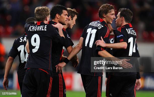 Michael Ballack of Leverkusen celebrates with team mates after scoring his teams second goal during the UEFA Champions League group E match between...