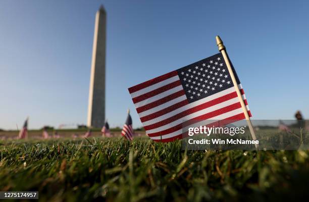 American flags at a COVID Memorial Project installation of 20,000 flags are shown on the National Mall as the United States crosses the 200,000 lives...