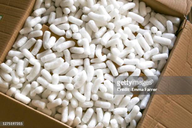 large brown box full of packaging materials - packing foam stock pictures, royalty-free photos & images