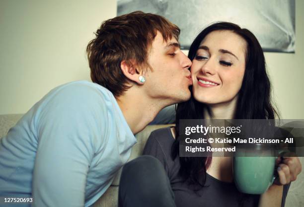 man kissing woman - young couple kiss ストックフォトと画像