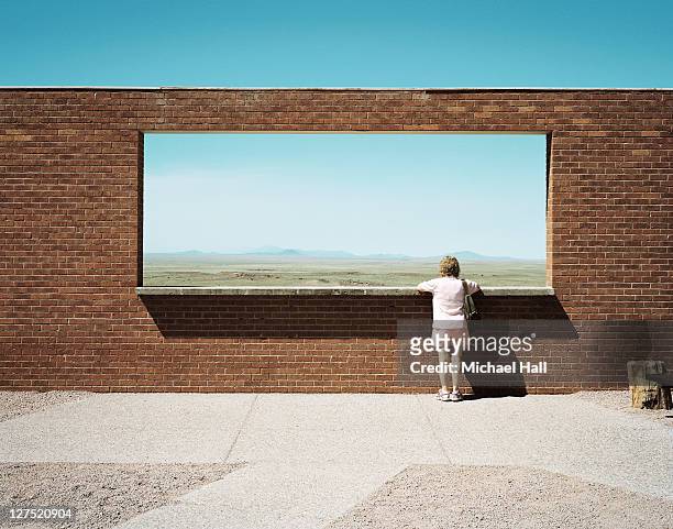 woman at meteor crater viewpoint - window frame stock pictures, royalty-free photos & images
