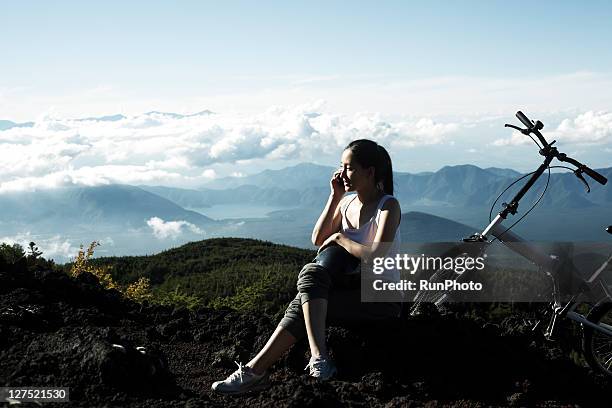 young woman talking mobile phones in the mountains - tokai region stock-fotos und bilder