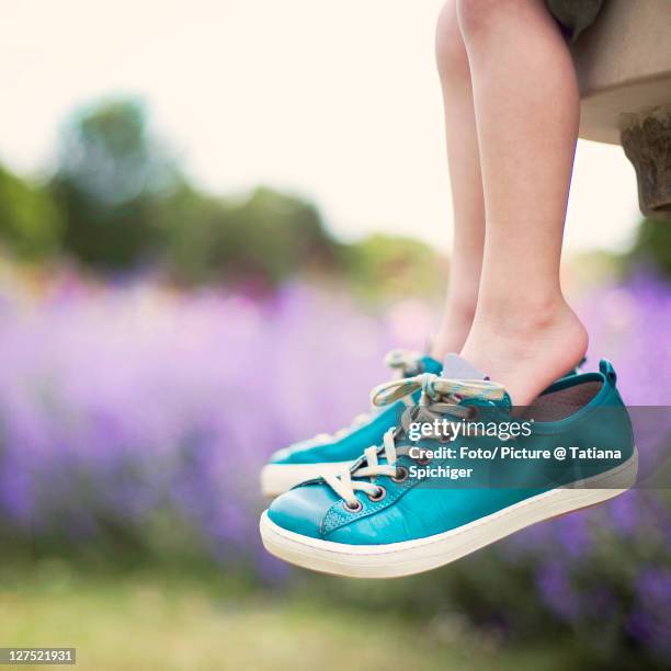 little feet, big shoes - big foot stock pictures, royalty-free photos & images