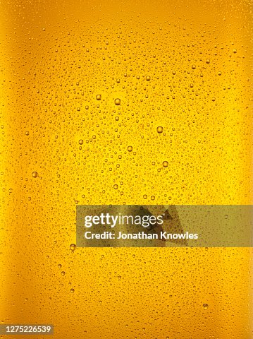 Condensation droplets on beer glass Condensation droplets on beer glass