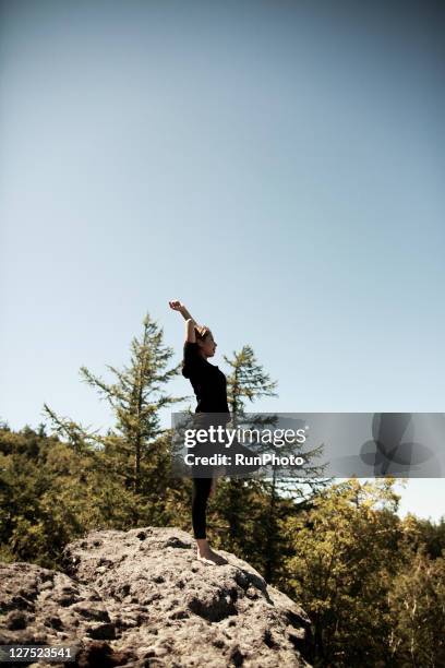 young woman doing yoga in the mountains - tree position stock pictures, royalty-free photos & images