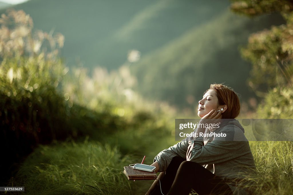 Young woman listening to music outside