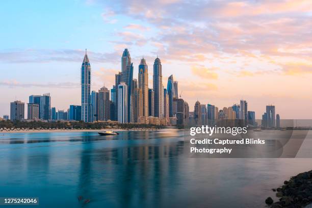 dubai marina from the sea side during sunset - dubai financial district stock pictures, royalty-free photos & images