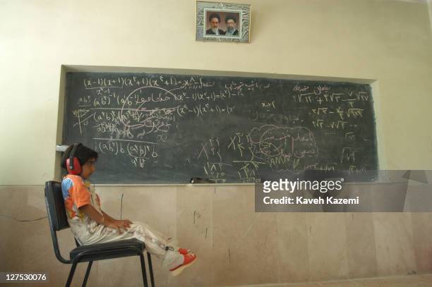 Young girl takes a hearing test as part of a pre-school medical check-up at a makeshift clinic in a school in Shahrekord, Chahar Mahaal and...