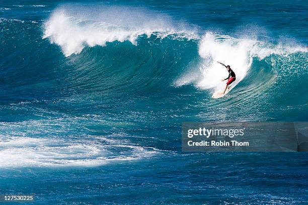 surfing at hookipa beach - hawaii seascape stock pictures, royalty-free photos & images