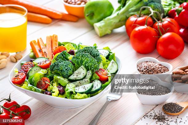 vegan food: healthy salad plate on white table. - fiber food stock pictures, royalty-free photos & images