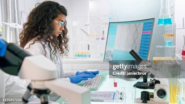 multi ethnic laboratory team at work. senior doctor using microscope. - old laboratory stock pictures, royalty-free photos & images