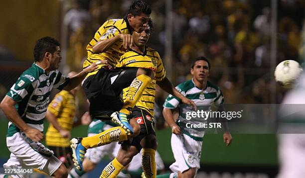 Eder Delgado , of Honduran Real Espana kicks the ball followed by Mexican Santos´players at Francisco Morazan Stadium in San Pedro Sula, Honduras on...