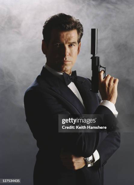 Irish actor Pierce Brosnan as 007 in a publicity still for the James Bond film 'The World Is Not Enough', 1999. He is wielding a Walther P99 with a...