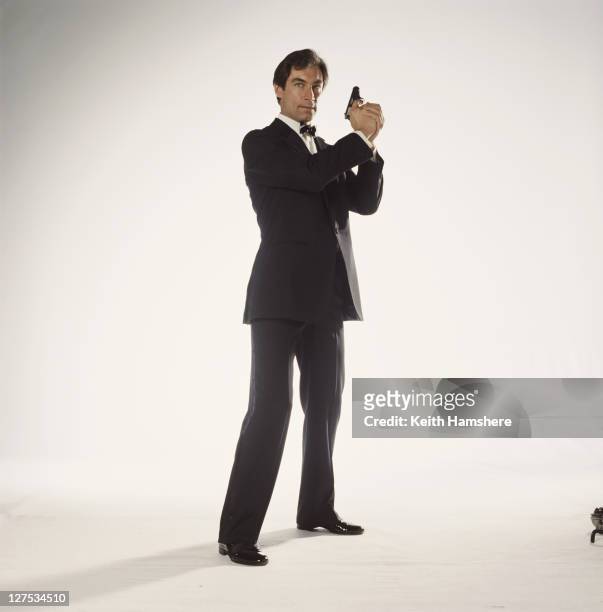 Welsh actor Timothy Dalton poses as 007 in a publicity still for the 1987 James Bond film 'The Living Daylights', 1986. He is holding his trademark...