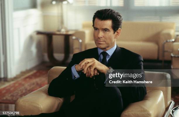 Irish actor Pierce Brosnan stars as 007 in the James Bond film 'The World Is Not Enough', 1999. Here he visits the offices of a Swiss banker in the...