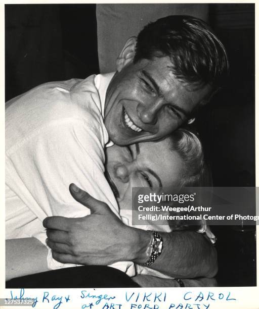 American singer and musician Johnnie Ray and singer Vikki Carol hug one an other at a birthday celebration for WNEW radio disk jocky Art Ford, New...