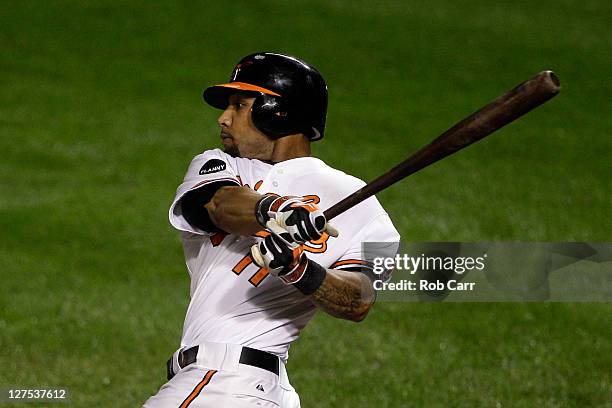 Robert Andino of the Baltimore Orioles follows his game winning hit to defeat the Boston Red Sox 4-3 at Oriole Park at Camden Yards on September 28,...