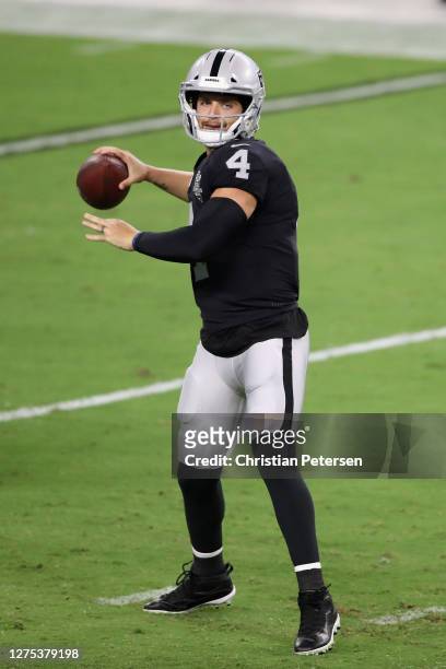 Quarterback Derek Carr of the Las Vegas Raiders drops back to pass during the NFL game against the New Orleans Saints at Allegiant Stadium on...