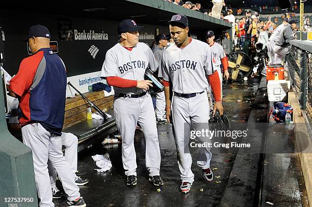 Carl Crawford of the Boston Red Sox walks in the dugout with first base coach Ron Johnson after a 4-3 loss against the Baltimore Orioles at Oriole...