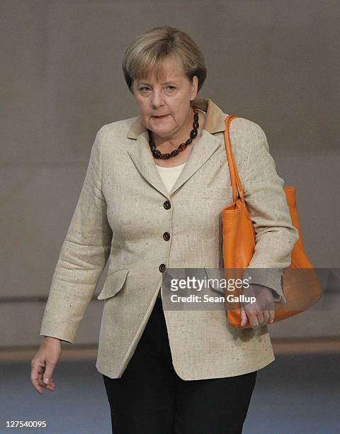 German Chancellor Angela Merkel arrives at a session of the Bundestag in which members will vote on an increase in funding for the European Financial...