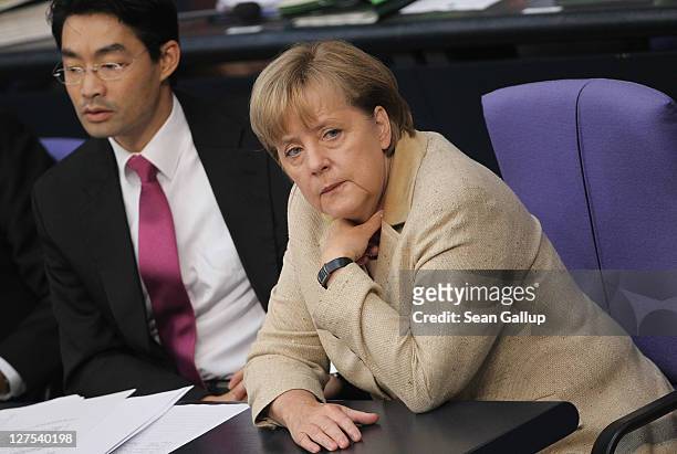 German Chancellor Angela Merkel and Vice Chancellor and Economy Minister Philipp Roesler attend a session of the Bundestag in which members will vote...