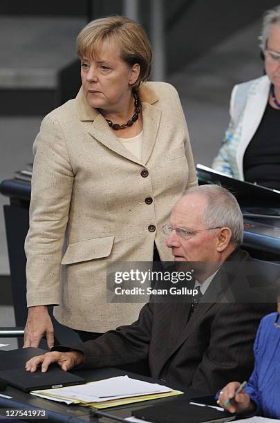 German Chancellor Angela Merkel and Finance Minister Wolfgang Schaeuble attend a session of the Bundestag in which members will vote on an increase...