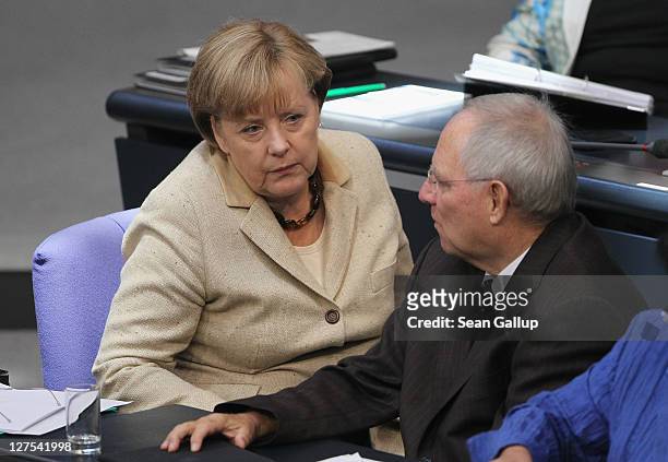 German Chancellor Angela Merkel and Finance Minister Wolfgang Schaeuble attend a session of the Bundestag in which members will vote on an increase...