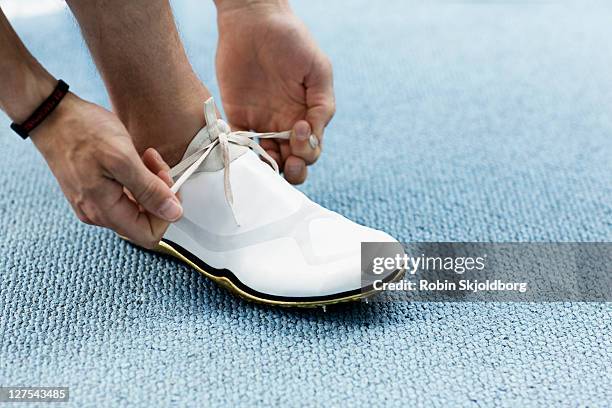 runner tying shoelaces - studded footwear stock pictures, royalty-free photos & images