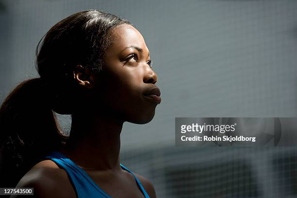 woman looking up into light - sportsperson stock pictures, royalty-free photos & images