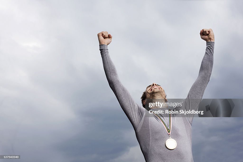 Cheering runner wearing medal