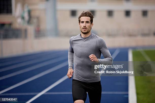 man running on track - runner man stock pictures, royalty-free photos & images