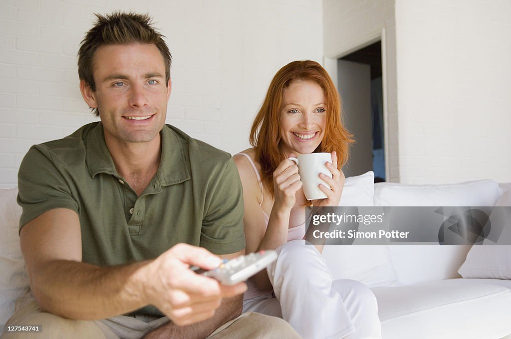 Couple watching television together