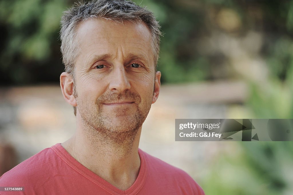 Man smiling in backyard