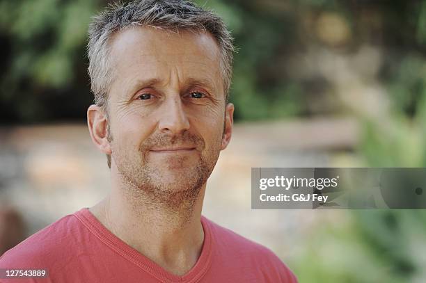 man smiling in backyard - 45 49 years stock pictures, royalty-free photos & images