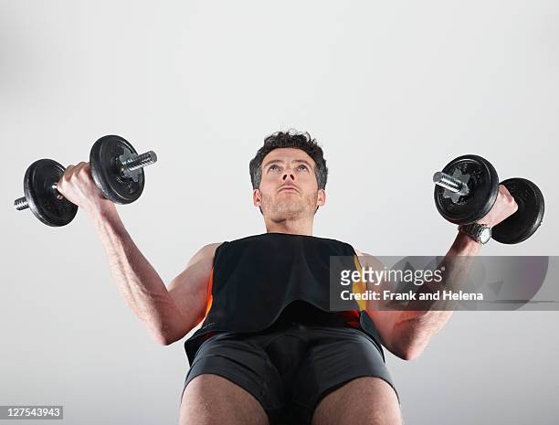 vista de ângulo baixo de homem levantando pesos - weight lifting imagens e fotografias de stock