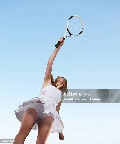 low angle view of woman playing tennis - blue tennis racket stock pictures, royalty-free photos & images