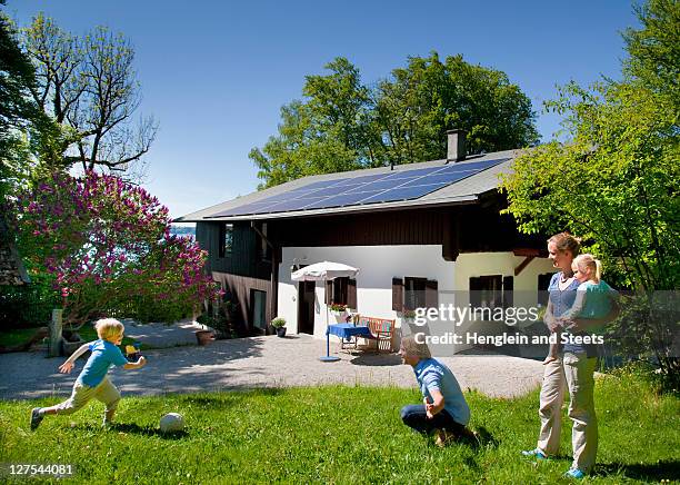 family at home with solar panel - houses in the sun stock pictures, royalty-free photos & images