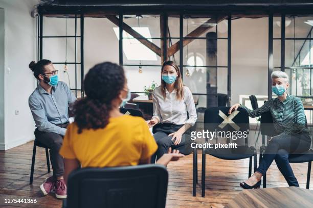 distancing during a business meeting - small group of people stock pictures, royalty-free photos & images