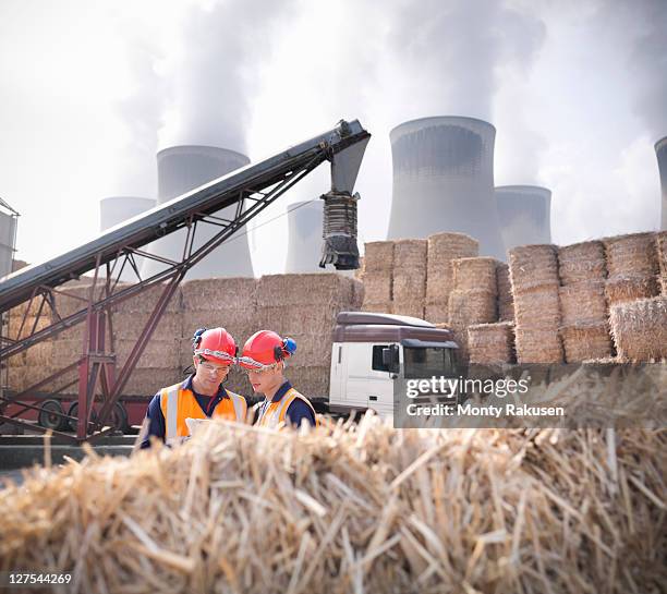 workers in biomass fuel facility - biomasse stock-fotos und bilder