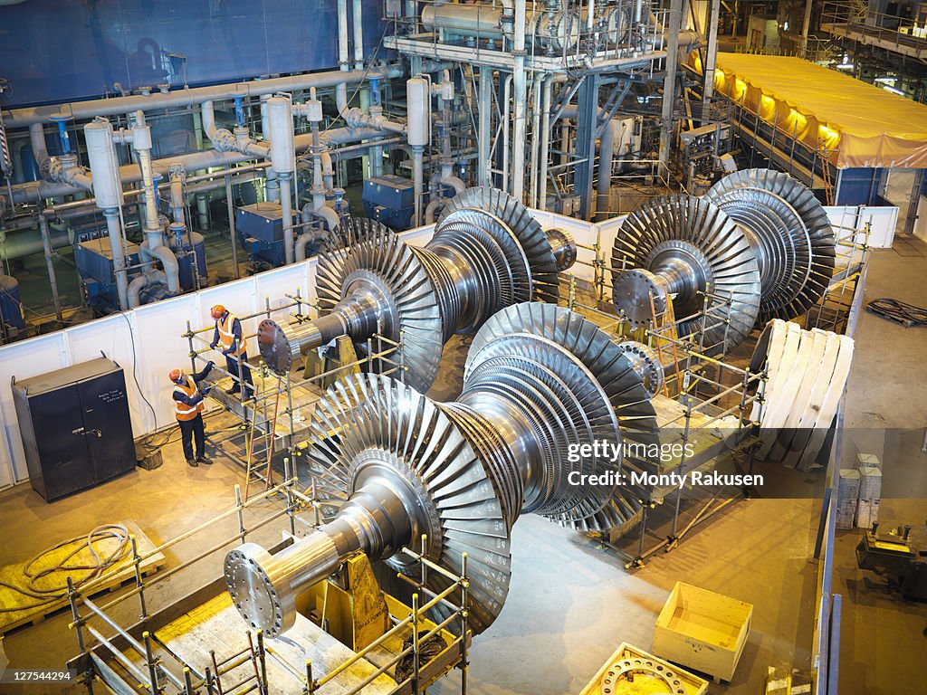 Workers with turbines in power station