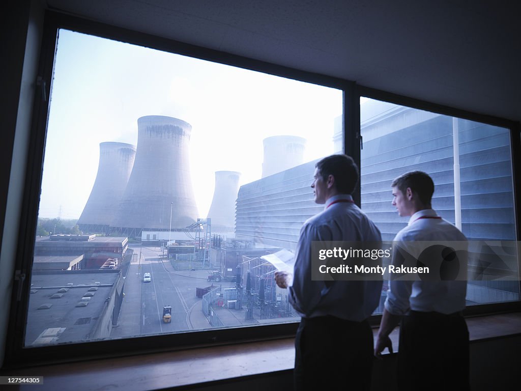 Workers looking out over power station