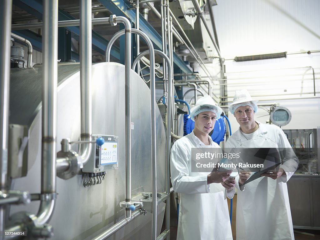 Workers inspecting goat yogurt in dairy