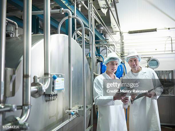 workers inspecting goat yogurt in dairy - vat stock pictures, royalty-free photos & images