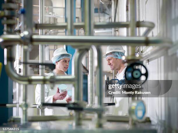 workers inspecting goat yogurt in dairy - milk plant stock-fotos und bilder