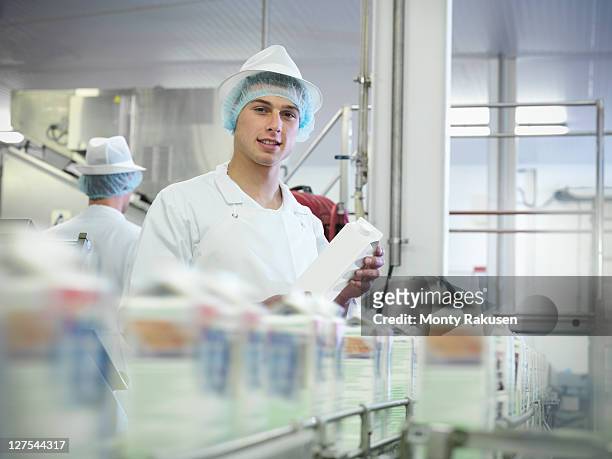 worker inspecting goat's milk in dairy - food and drink industry fotografías e imágenes de stock