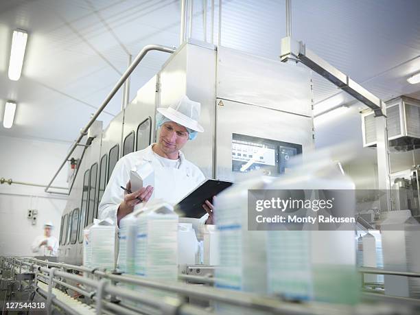 worker inspecting goat's milk in dairy - food and drink industry stock-fotos und bilder