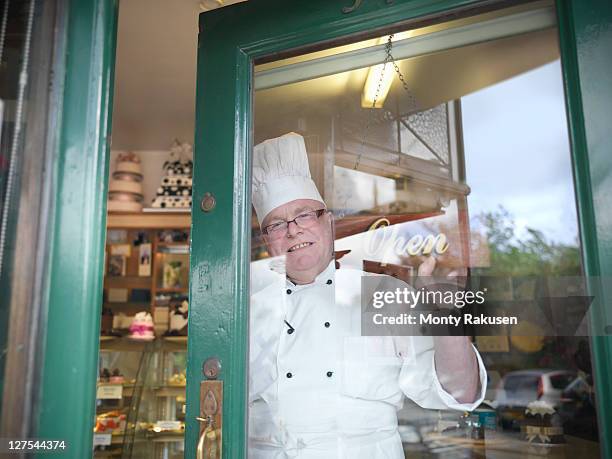 baker opening his cake shop - bakery window stock pictures, royalty-free photos & images