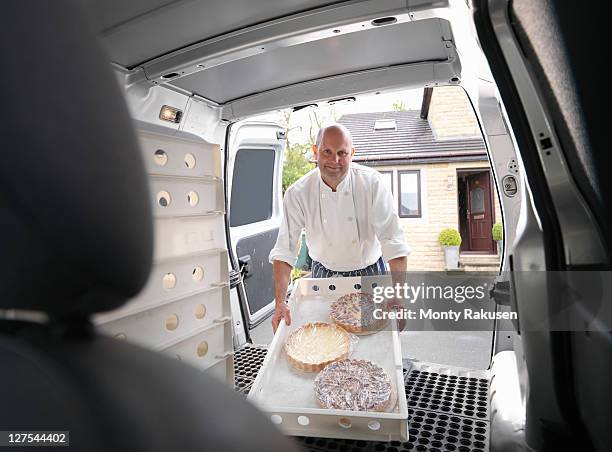 pastry chef loading cakes into van - baker occupation stock pictures, royalty-free photos & images